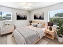 Serene bedroom featuring neutral tones, a large window with blinds, and tasteful artwork at 4000 Barbary Ln, North Port, FL 34287