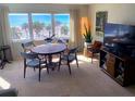 Inviting dining room featuring a wooden table with seating and a large window with ocean views at 500 The Esplanade N # 405, Venice, FL 34285