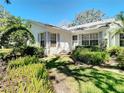 Single-story home featuring tidy landscaping, well-manicured lawn, and gray shutters at 4215 Edgewood Dr, Holiday, FL 34691