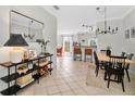 Inviting dining room with stylish light fixture and a decorative console table with a mirror at 2607 W Cleveland St # B, Tampa, FL 33609