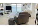 Cozy living room with waterfront view and comfortable seating including recliner and ottoman at 7300 Sun Island S Dr # 1004, South Pasadena, FL 33707