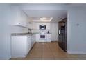 Modern eat-in kitchen featuring stainless steel appliances and white cabinets at 3818 Moog Rd, Holiday, FL 34691