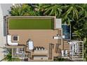 Aerial view of roof top deck with a pool, outdoor kitchen, lounging and dining areas at 415 N Bay Blvd, Anna Maria, FL 34216