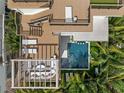 Aerial view of the pool, outdoor kitchen, seating, and sunbathing area at 415 N Bay Blvd, Anna Maria, FL 34216