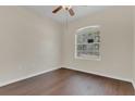 Cozy bedroom with hardwood floors, neutral paint, and a large window at 11530 57Th Street E Cir, Parrish, FL 34219