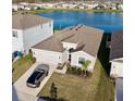 Aerial view of home featuring a large lake view and car parked in the driveway at 345 Mangrove Manor Dr, Apollo Beach, FL 33572