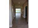 Inviting hallway with tile flooring leading to a living area with water views at 345 Mangrove Manor Dr, Apollo Beach, FL 33572