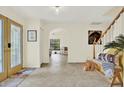 Bright foyer with tile flooring, complemented by a charming wooden bench and staircase at 11419 Donneymoor Dr, Riverview, FL 33569