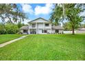 Inviting two-story home boasting lush green lawn, balcony, and charming curb appeal at 11419 Donneymoor Dr, Riverview, FL 33569