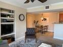 Cozy living room showcases neutral walls, tiled flooring, and flows into dining area for open layout at 455 Alt 19 S # 65, Palm Harbor, FL 34683