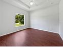 Bright bedroom with ample natural light, tray ceiling and hardwood floors at 3328 Circleville St, North Port, FL 34286