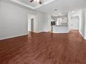 Open-concept living room with wood floors and seamless flow into kitchen and entry at 3328 Circleville St, North Port, FL 34286