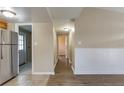 Bright hallway featuring modern lighting and access to the kitchen and other rooms at 7216 E Emma St, Tampa, FL 33610