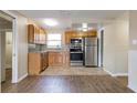 Well-lit kitchen with stainless steel appliances, wooden cabinets, and a stylish backsplash at 7216 E Emma St, Tampa, FL 33610