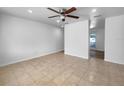 Bright living room features neutral decor, tile flooring and ceiling fan at 913 27Th E St, Bradenton, FL 34208