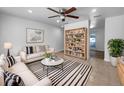 Bright living room features neutral decor, tile flooring and stylish striped rug at 913 27Th E St, Bradenton, FL 34208