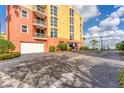 Condominium parking area featuring multiple garage doors and covered parking with waterfront views at 606 Riviera Dunes Way # 604, Palmetto, FL 34221