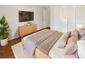 Comfortable bedroom featuring a plush bed, modern dresser, mounted TV, and ample natural light at 8379 Begonia St, Spring Hill, FL 34608