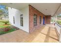 Wide front porch with brick and siding, offering a perfect spot for relaxing outdoors at 6604 Stafford Terrace Ave, Plant City, FL 33565