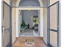 View from the front doorway into a tiled foyer and open-concept living space of home at 821 Greenview Dr, Apollo Beach, FL 33572