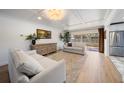 Bright living room with coffered ceiling, hardwood floors, and a neutral color palette at 7746 Westmoreland Dr, Sarasota, FL 34243