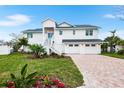 Beautiful two-story home boasts a three-car garage and brick-paved driveway at 1903 Gulfview Dr, Holiday, FL 34691