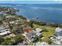 Expansive aerial view showcases the home's waterfront location with easy access to the bay and private dock at 606 Indiana Ave, Crystal Beach, FL 34681