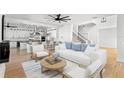 Bright, open-concept living room and kitchen with hardwood floors and modern furnishings at 606 Indiana Ave, Crystal Beach, FL 34681