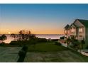 Beautiful waterfront view featuring a spacious lawn leading to the water, offering serenity and natural beauty at 606 Indiana Ave, Crystal Beach, FL 34681
