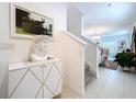 Elegant home entryway with modern decor, a staircase, and neutral tones at 6744 Back Forty Loop, Zephyrhills, FL 33541