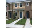 Townhome exterior featuring neutral tones and well-maintained landscaping at 7037 Towering Spruce Dr, Riverview, FL 33578