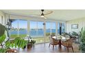 Inviting sun room with expansive windows offering stunning waterfront views and a cozy dining area at 6200 Flotilla Dr # 305, Holmes Beach, FL 34217