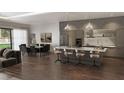 Open-concept kitchen with stainless steel appliances, large island, hardwood floors, and ample seating at 15945 Viscount Cir, Port Charlotte, FL 33981