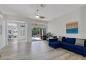 Modern living room with sliding glass doors to the pool area and a comfortable blue sectional sofa at 4721 Country Manor Dr, Sarasota, FL 34233