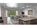 Inviting living room with hardwood floors, recessed lighting, and large windows showcasing outdoor views at 8259 Tracy Cir, Port Charlotte, FL 33981