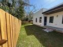 Fenced backyard with green grass, offering a private and secure outdoor space at 2604 E 11Th Ave, Tampa, FL 33605