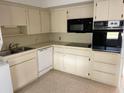 Functional kitchen with white cabinets, sleek countertops, and essential appliances at 4143 57Th N St # 502, Kenneth City, FL 33709