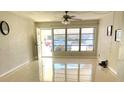 Bright living room with neutral walls, polished floors, and a large window overlooking the outside at 4143 57Th N St # 502, Kenneth City, FL 33709