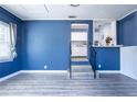 Spacious foyer with striking blue walls, a white wainscot, and stylish gray flooring at 4630 Grace N St, St Petersburg, FL 33714