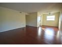 Spacious living room featuring dark wood floors, neutral walls, and abundant natural light at 6026 22Nd N Ave # 4, St Petersburg, FL 33710
