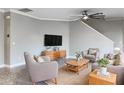 Bright living room with neutral walls, ceiling fan, and casual furniture arrangement at 6113 Shadowlake Dr, Apollo Beach, FL 33572
