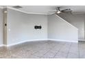 Bright, open living area featuring tile flooring, modern baseboards, and a mounted TV bracket at 6113 Shadowlake Dr, Apollo Beach, FL 33572