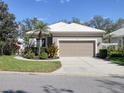 Charming home features an attached garage, and well-maintained landscaping at 5011 88Th E St, Bradenton, FL 34211