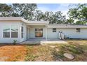 Backyard featuring a covered patio with sliding glass doors and plenty of yard space at 530 Foxglove Rd, Venice, FL 34293