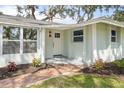 Inviting front entrance with brick walkway, manicured landscaping, and stylish front door at 530 Foxglove Rd, Venice, FL 34293