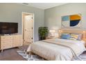 Cozy bedroom with a queen bed, modern decor, and a large window providing ample natural light at 14853 Crescent Rock Dr, Wimauma, FL 33598