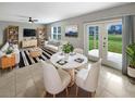 Bright living room featuring modern furniture, tile flooring, and sliding door access to the outdoors at 36880 Precita Ter, Zephyrhills, FL 33542