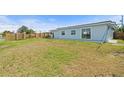 Spacious backyard with a wooden fence, providing privacy and room for outdoor activities and landscaping at 511 Sharon Cir, Port Charlotte, FL 33952