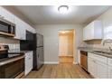 Modern kitchen with stainless steel appliances, white cabinets, and granite countertops at 2634 E 38Th Ave, Tampa, FL 33610