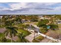 Beautiful home featuring a lush green lawn, palm trees, and a private fenced backyard at 1714 Bayou Grande Ne Blvd, St Petersburg, FL 33703